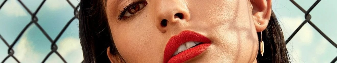 Maybelline Lipstick products illustrative banner image - Close up of woman wearing bright lipstick