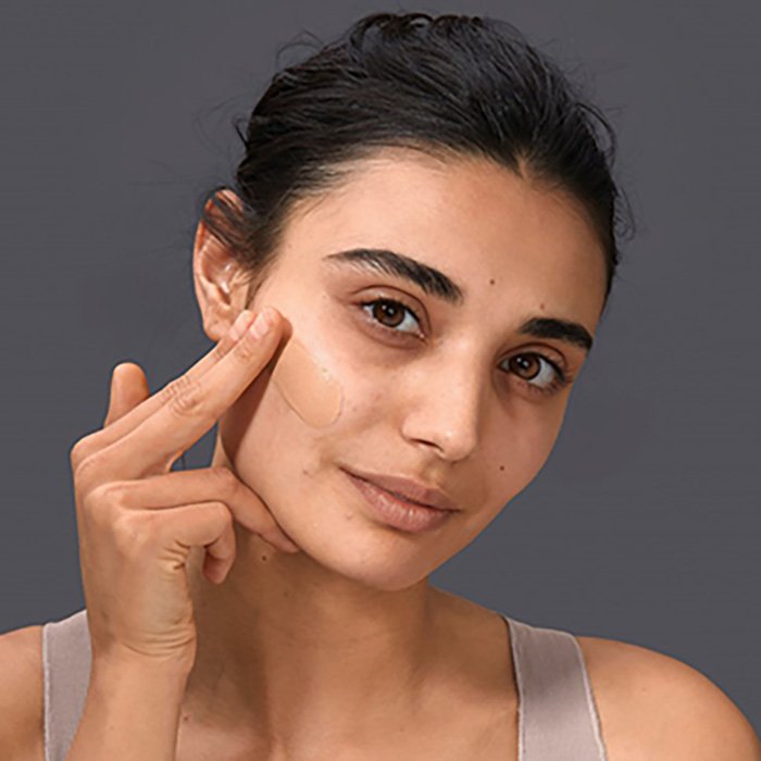 Women applying foundation